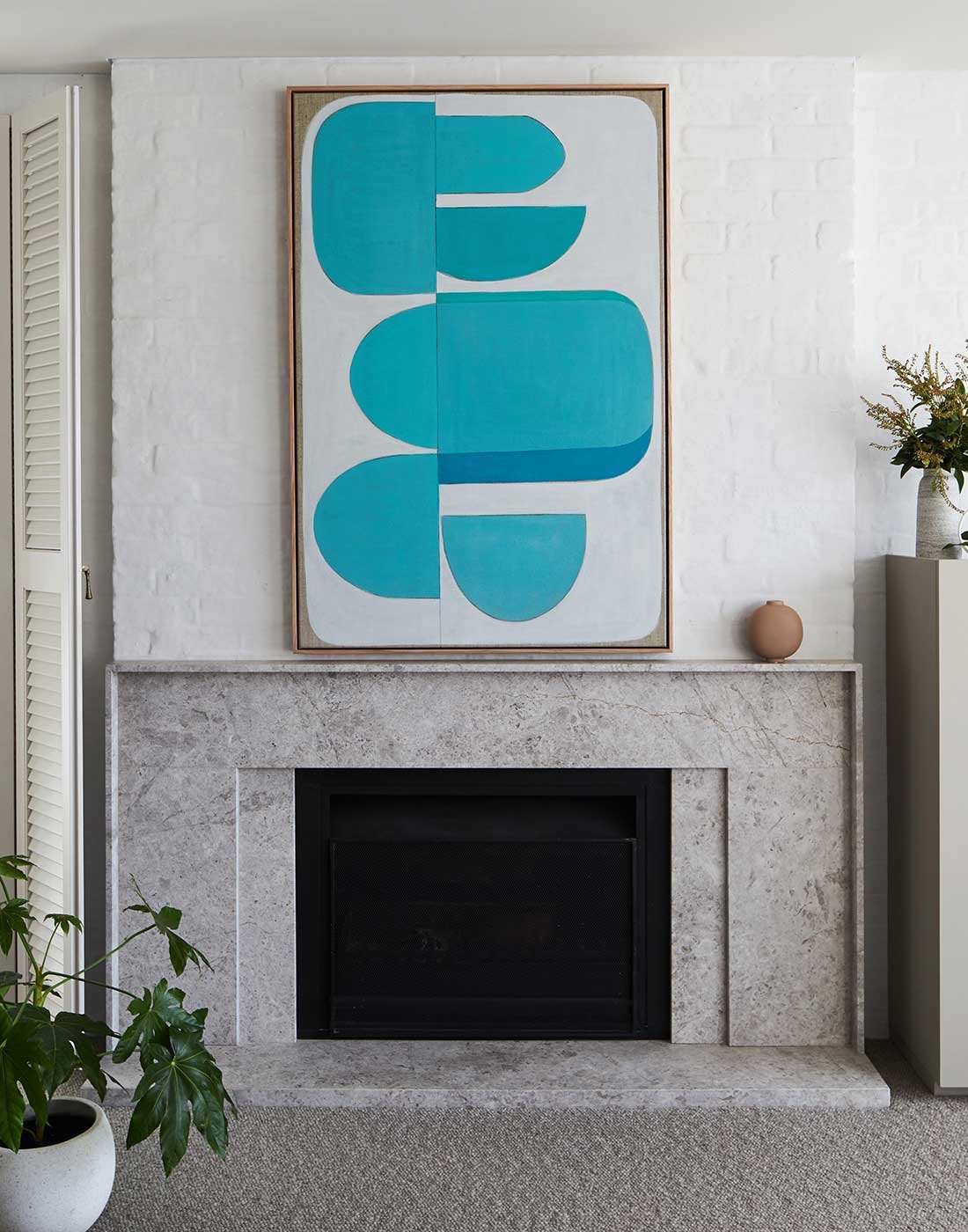 Large aqua abstract wall art above sofa in modern coastal living room