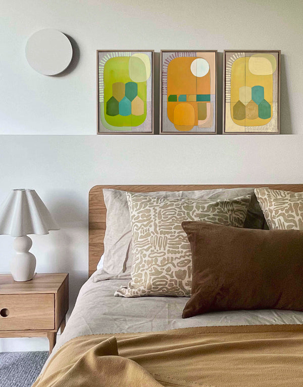 Bedroom with a bed, nightstand, and wall art