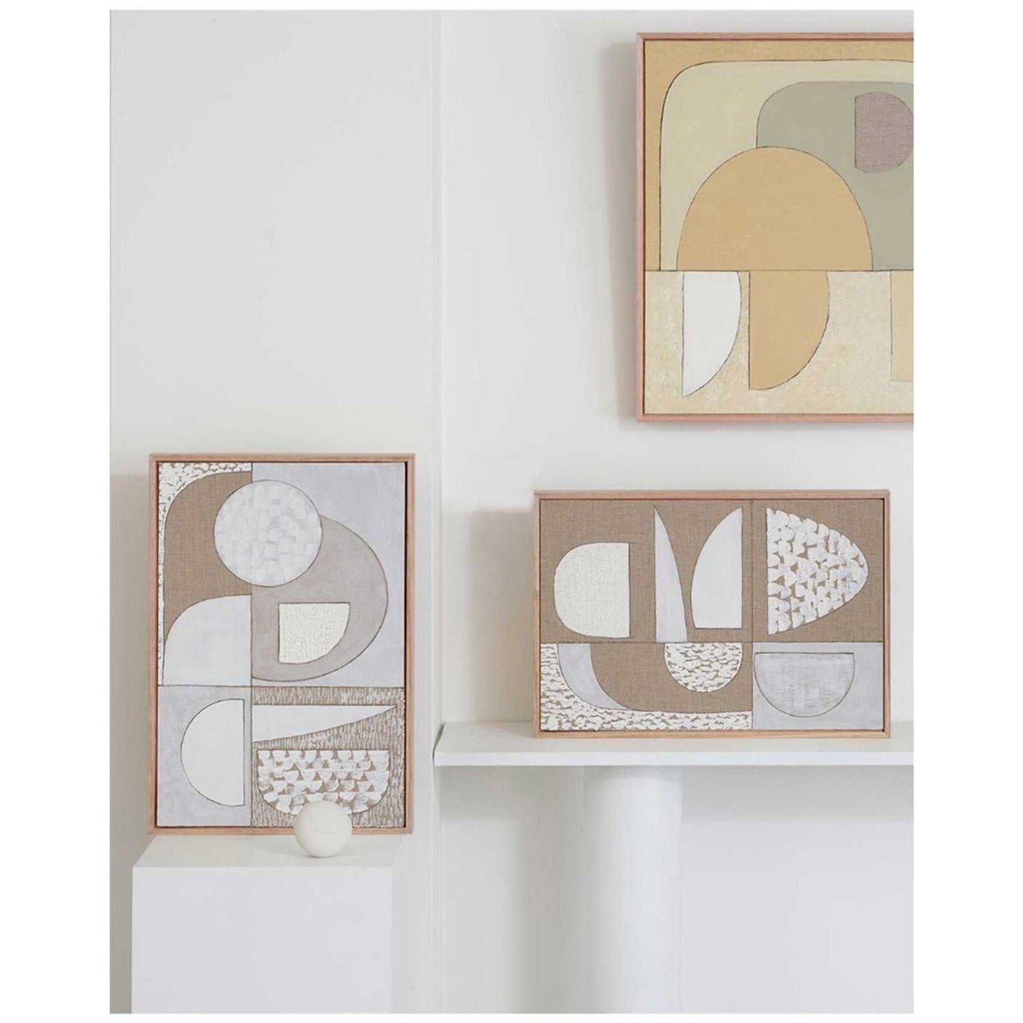 Framed Giclee prints featuring geometric artwork, with a warm, neutral Italian linen background and white titanium oil paint highlights, displayed on a white wall.