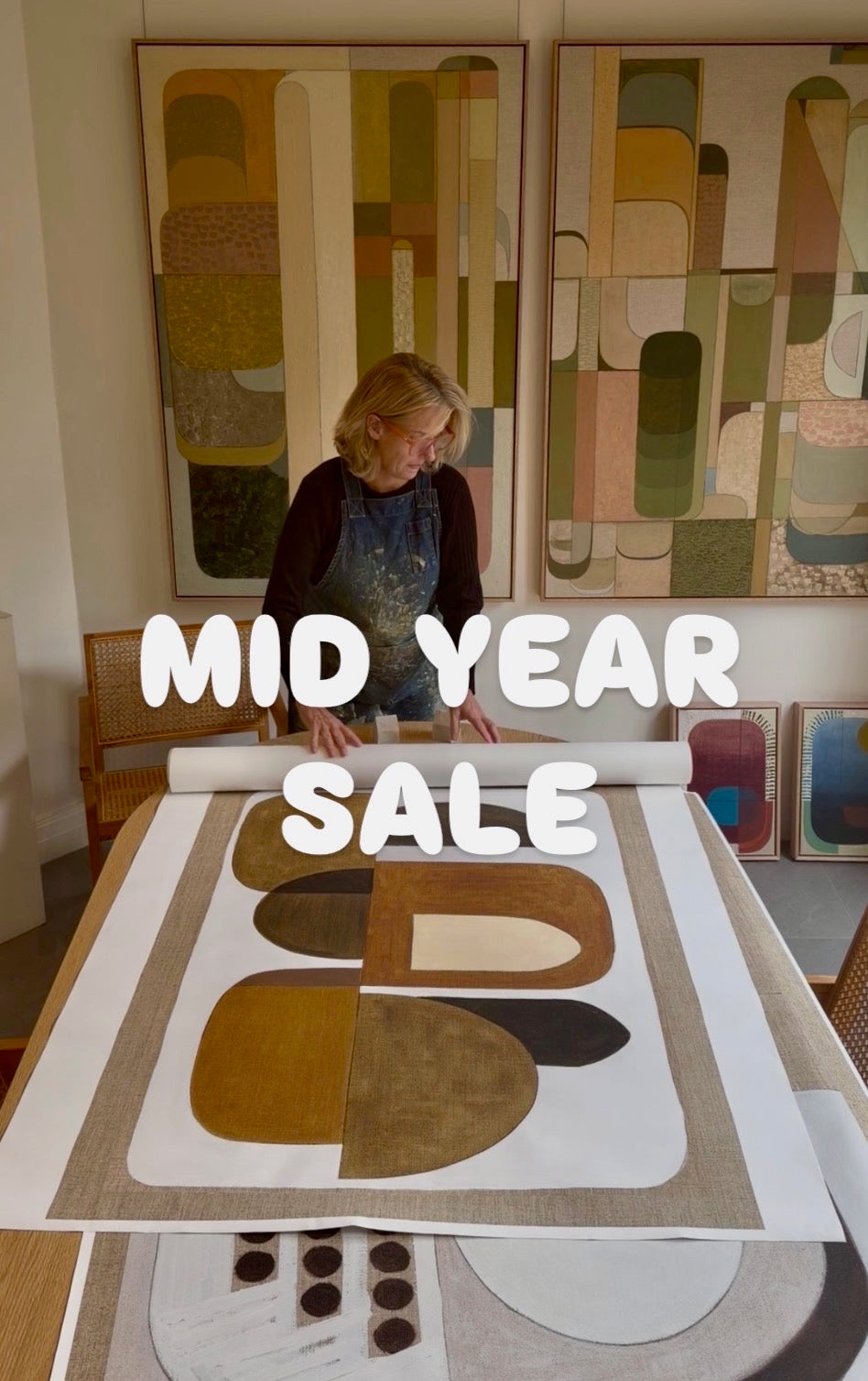 Sudio Elwood artistic designer Tory Burke working with giclee prints on table 