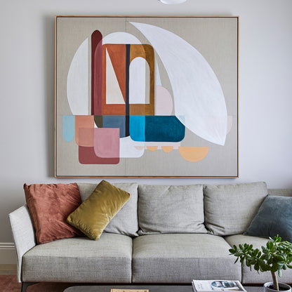 Gray sofa with colorful pillows and a large abstract painting on the wall.