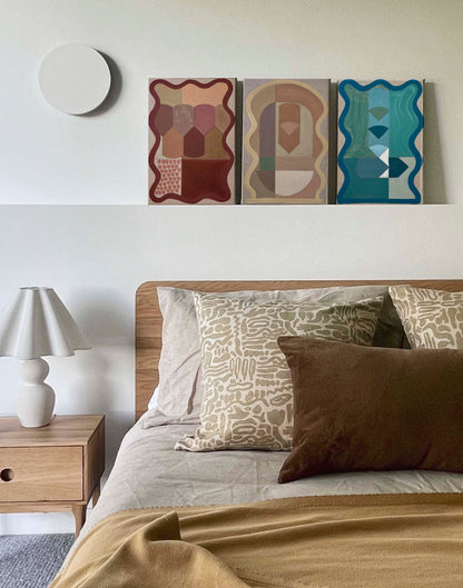 Bedroom with abstract wall art above the bed